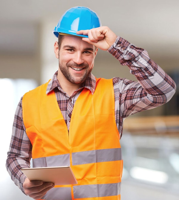 Man wearing a construction helmet and holding a tablet